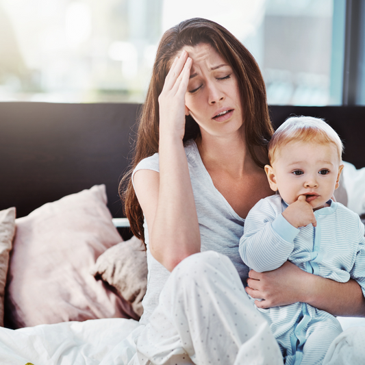 tired stressed mom holding baby